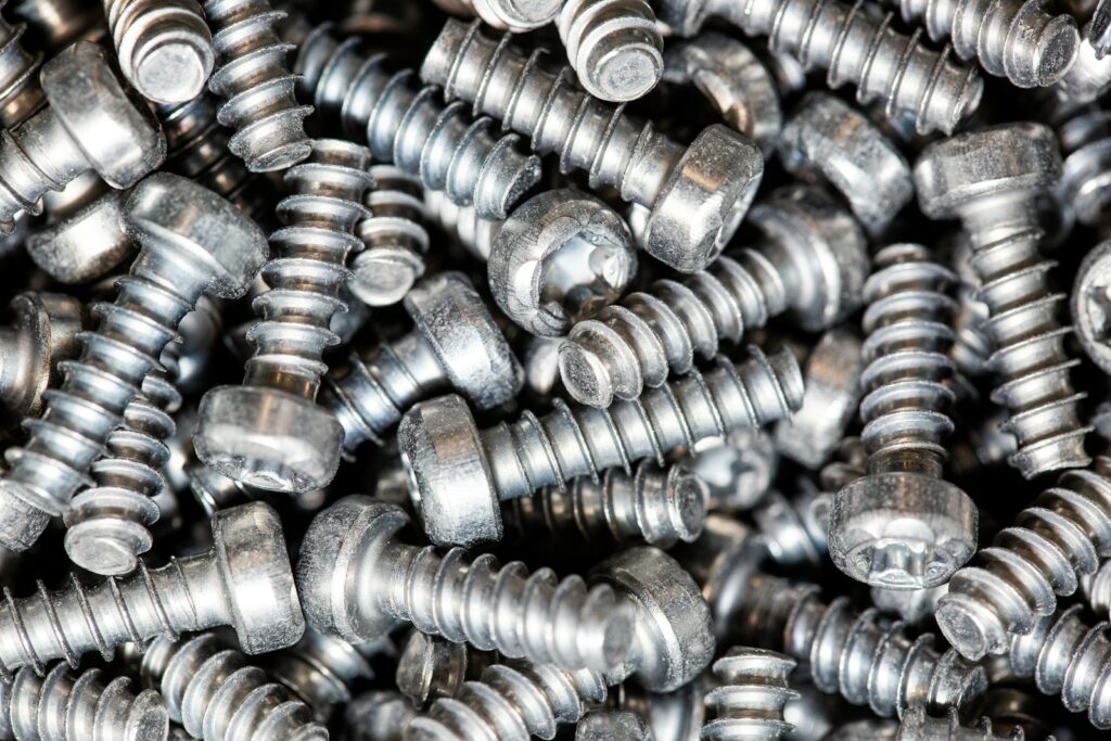Close-up of a heap of bright silver plated self-tapping screws