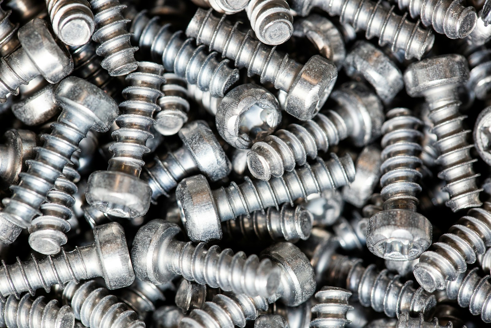 Close-up of a heap of bright silver plated self-tapping screws